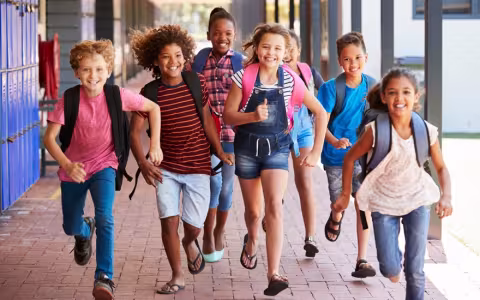 School kids running in elementary school hallway