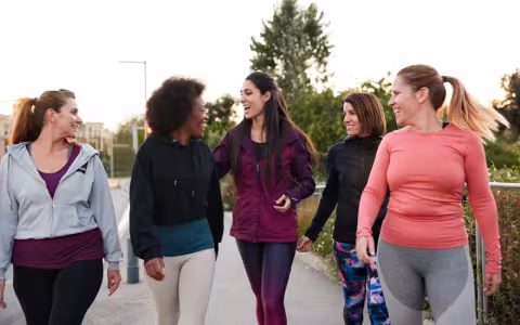 A group of women walking and talking after doing some outdoor exercise