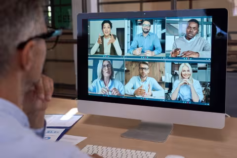 Diverse team having digital group virtual meeting on computer