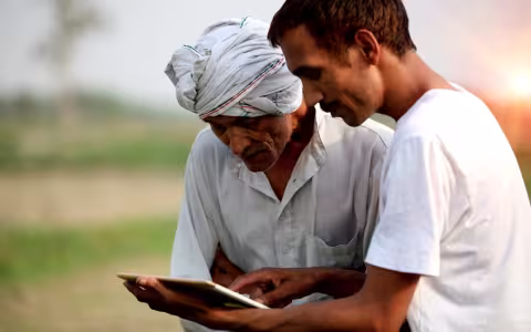 Agronomist consulting with farmer outdoor in the field