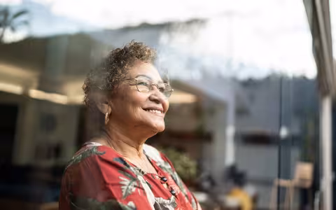 Happy senior woman contemplating at home