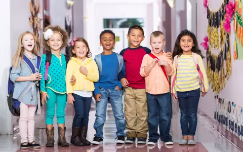 Multiracial group of children in preschool hallway