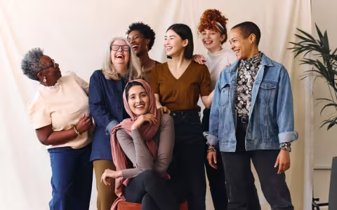 Portrait of cheerful mixed age range multi ethnic women celebrating International Women's Day